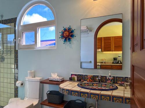 a bathroom with a sink and a mirror at Casa Sonoma - Charming Condos Minutes from Beach & Reef in Puerto Morelos