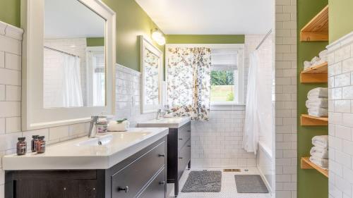 a bathroom with two sinks and a mirror at Bayview Together Farm by AvantStay in Clinton