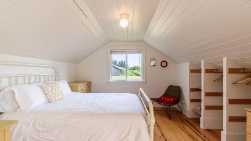 a bedroom with a white bed and a window at Bayview Together Farm by AvantStay in Clinton