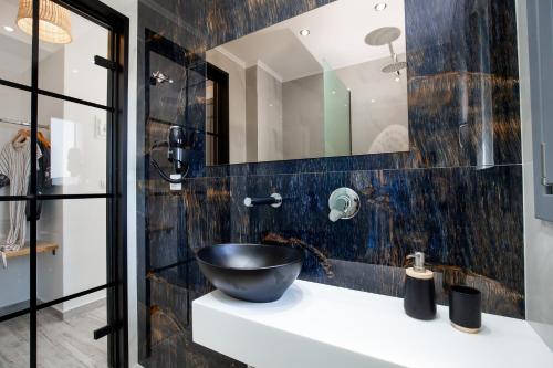 a bathroom with a sink and a mirror at East Coast in Alyki