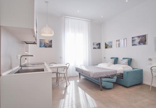a kitchen with a sink and a bed in a room at Casa Contra in La Spezia