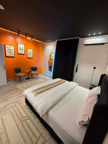 a bedroom with a large bed and two chairs at شقة فاخرة بجاكوزي وبلياردو دخول ذاتي in Hail