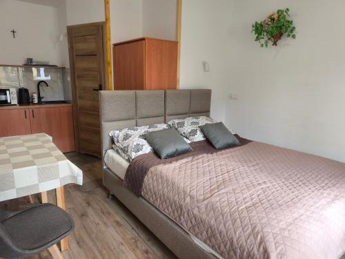 a bedroom with a bed with two pillows on it at Za potokiem-Solina 66-77-44-4-61 in Solina