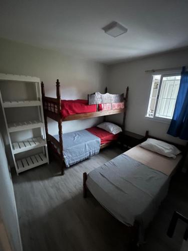 a bedroom with two bunk beds and a window at Mansilla playa in Mar del Plata