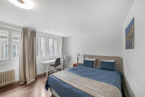 ein Schlafzimmer mit einem Bett und einem Schreibtisch mit Stuhl in der Unterkunft Boel 4 Studio in Genf