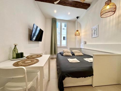 a bedroom with a bed and a table and a desk at Casa Sauge in Grasse