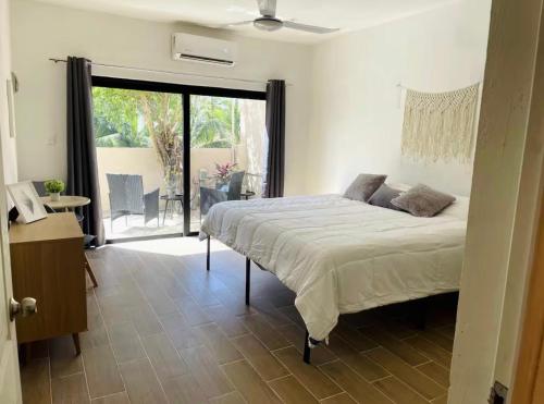 a bedroom with a bed and a sliding glass door at Mar y Chelo Luxury Aparments in Isla Mujeres