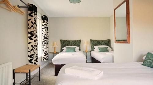 a room with three beds and a mirror at Fitz of Inch - Entire Venue Rental in Stradbally