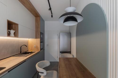 a kitchen with a wooden table and chairs at The Aristocrat by D'or Selection in Bucharest