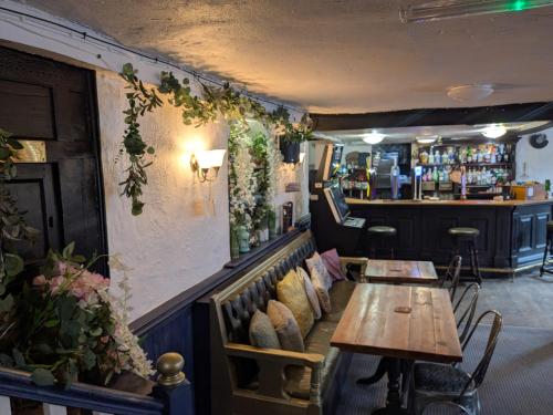 a restaurant with two tables and a bar at The Unicorn Inn in Richmond