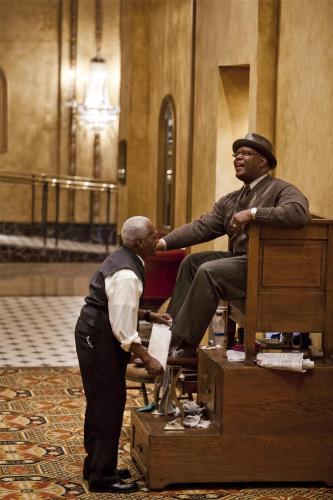 a man is giving a man a mans shoe at The Roosevelt Hotel New Orleans - Waldorf Astoria Hotels & Resorts in New Orleans