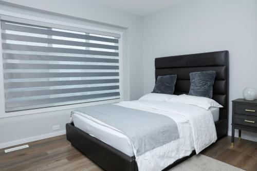 a bedroom with a large bed and a window at Kris Comfort Garden Suite in Edmonton
