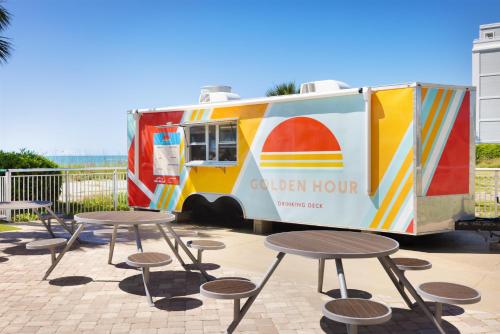 a food truck is parked next to some tables at Hampton Inn & Suites Myrtle Beach Oceanfront in Myrtle Beach