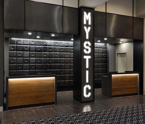 a lobby with a sign that says subway at Hilton Mystic in Mystic