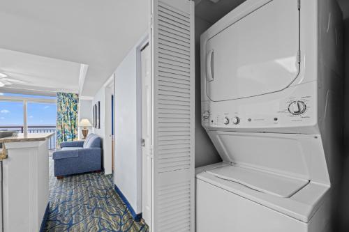 a kitchen with a washer and dryer in a room at Paradise Resort in Myrtle Beach