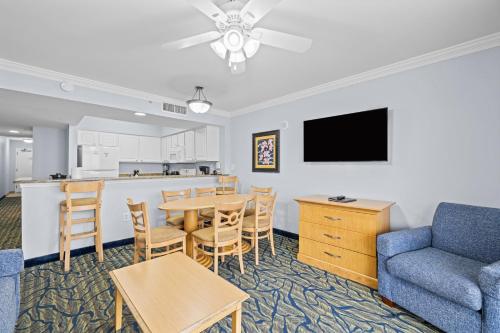 a living room with a table and a couch and a kitchen at Paradise Resort in Myrtle Beach