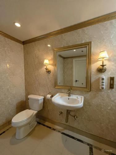 a bathroom with a toilet and a sink and a mirror at Hotel Krone International in Gurgaon