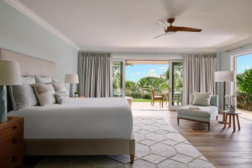a bedroom with a white bed and a balcony at Ho'olei at Grand Wailea in Wailea