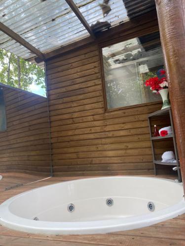 a bath tub in a room with a wooden wall at Hotel Inversiones Napoles in Doradal