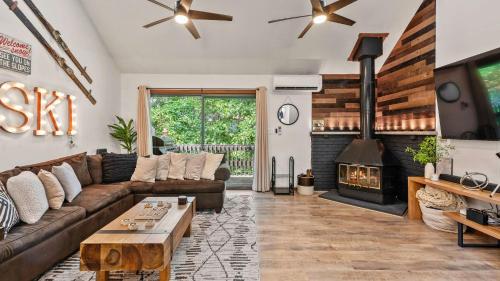 a living room with a couch and a fireplace at The Bears Den by AvantStay Prime Location Renovated w Movie Game Room in Crescent Lake