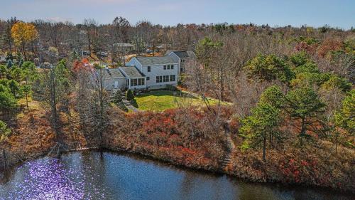 an aerial view of a large house on the water at Lakers Pointe by AvantStay Lakefront Private Peninsula Hot Tub Game Room in Long Pond