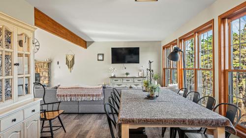 a dining room with a table and chairs at Lakers Pointe by AvantStay Lakefront Private Peninsula Hot Tub Game Room in Long Pond