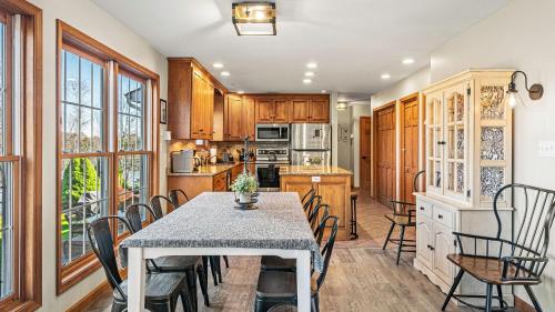 a kitchen and dining room with a table and chairs at Lakers Pointe by AvantStay Lakefront Private Peninsula Hot Tub Game Room in Long Pond
