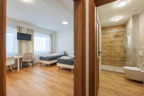 a bathroom with a bed and a tub in a room at Penzion U Leopolda in Brno