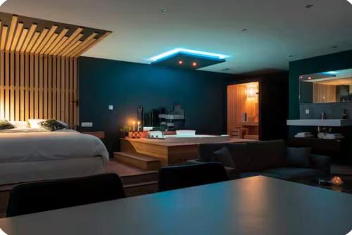 a bedroom with a bed and a living room at Loveroom Lens in Lens