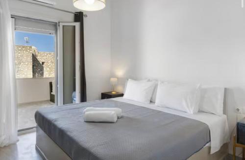 a bedroom with a bed with a towel on it at Sunset Realty in Ano Syros
