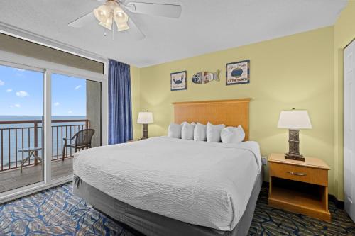 a hotel room with a bed and a balcony at Paradise Resort in Myrtle Beach