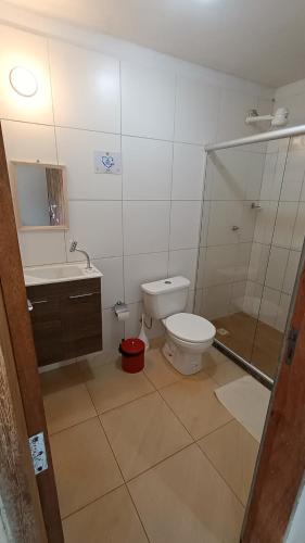 a bathroom with a toilet and a sink and a shower at Albacora Eco Residence in Imbassai