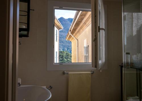 a bathroom with a sink and a window at Luxury Apartment in Moltrasio Center in Moltrasio
