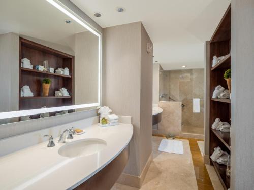 a bathroom with a sink and a large mirror at Signia by Hilton Orlando - An Official Walt Disney World Hotel in Orlando