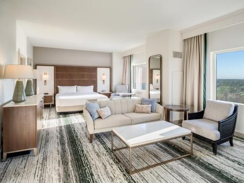 a hotel room with a bed and a living room at Signia by Hilton Orlando - An Official Walt Disney World Hotel in Orlando