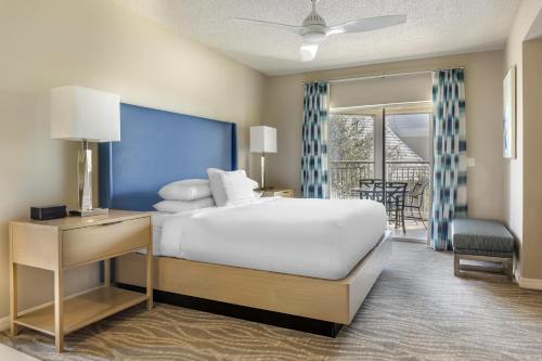a hotel room with a bed and a balcony at Hilton Grand Vacations Club SeaWorld Orlando in Orlando