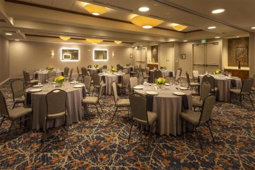 a banquet room with tables and chairs and tablesearcher at Hilton Garden Inn Seattle/Issaquah in Issaquah