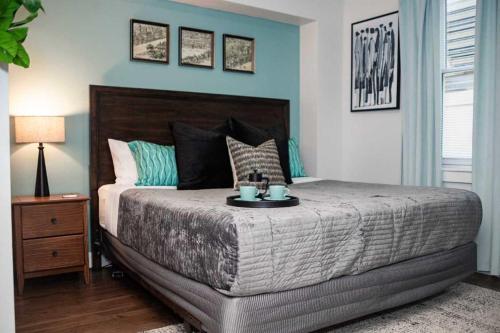 a bedroom with a large bed with blue walls at Fun Cozy 1 Br King Apts - 1 25 Mile Walk to TIAA Bnk Fld in Jacksonville