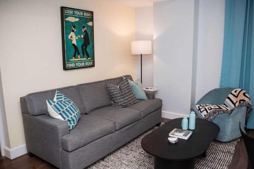 a living room with a couch and a table at Fun Cozy 1 Br King Apts - 1 25 Mile Walk to TIAA Bnk Fld in Jacksonville