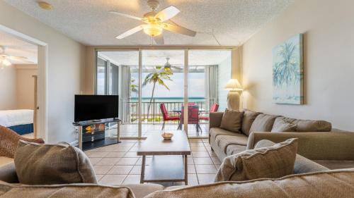 a living room with a couch and a tv at Brisa Del Mar by AvantStay Communal Pool Gated Community Ocean Front in Key West