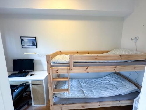 a bedroom with two bunk beds and a desk at The Seabreeze Marina in Mandal