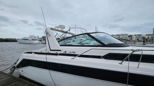 a white boat docked at a dock in the water at Lisboa Barco Gold Prestige Marina Parque das Nações in Lisbon