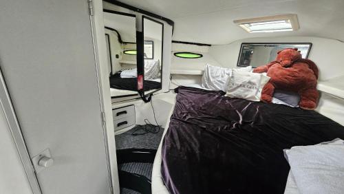 a teddy bear sitting on a bed in an rv at Lisboa Barco Gold Prestige Marina Parque das Nações in Lisbon