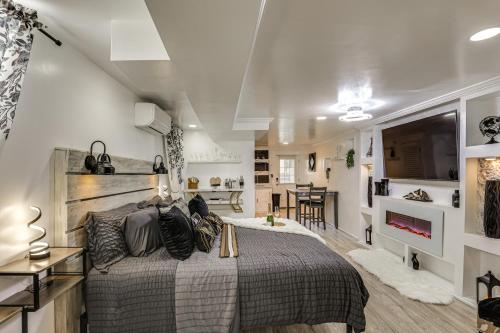 a bedroom with a bed and a living room at Oasis Hideaway Apt w/ Rainforest Shower! in Baltimore