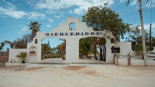a white building with a sign that reads blivenneelandoss at Buena Vista Oceanfront & Hot Springs Resort in Buenavista