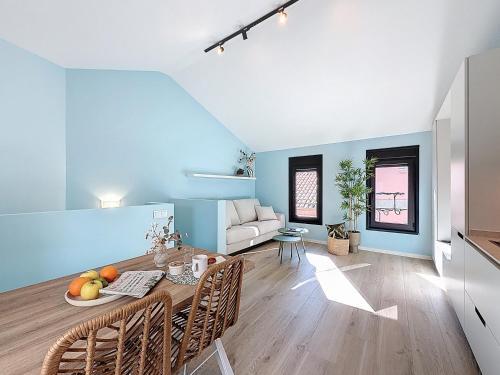 a dining room with blue walls and a table and chairs at Casa PedraParda in O Grove