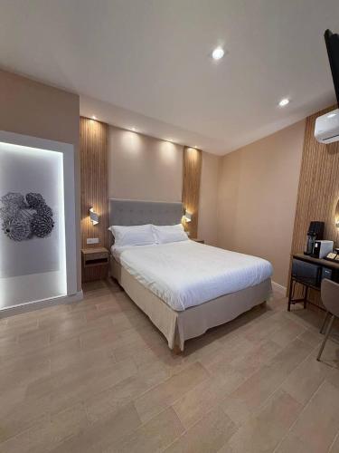 a bedroom with a large bed and a desk at Windofsand Room in Cagliari
