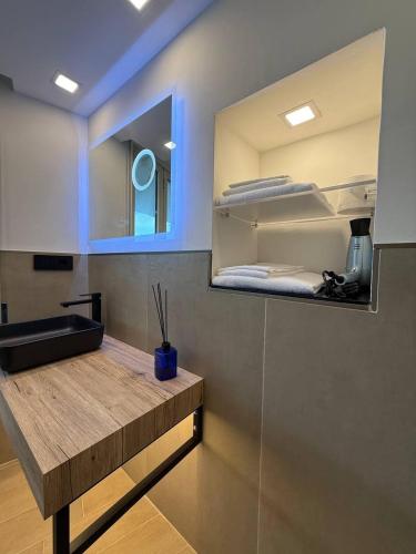 a room with a counter with a mirror and a bed at Windofsand Room in Cagliari