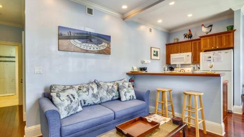 a living room with a blue couch and a kitchen at Paradise Place by AvantStay Key West Old Town Condo w Shared Pool in Key West