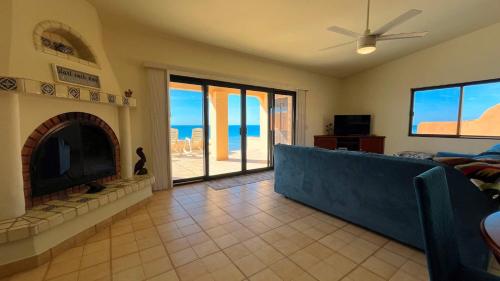 a living room with a couch and a fireplace at Charming 3-Bedroom Beachfront Home Bahia Delfin in Las Conchas